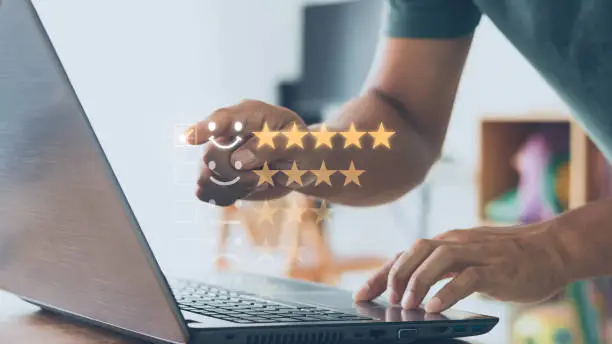 Photo of Customer service and Satisfaction concept, Businessperson are touching the virtual screen on the happy Smiley face icon to give satisfaction in service. By giving the most satisfaction rating 5 stars.