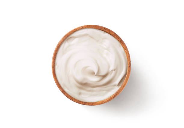 Sour cream in a wooden bowl
