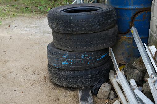 Pile of used car tires in a tire repair shop