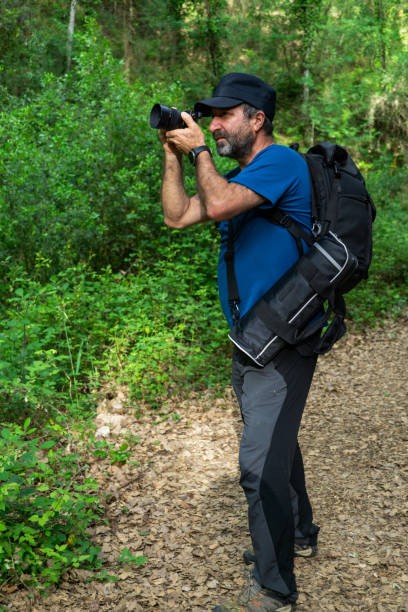 istock man with beard and cap taking a picture of a flower 1399129367