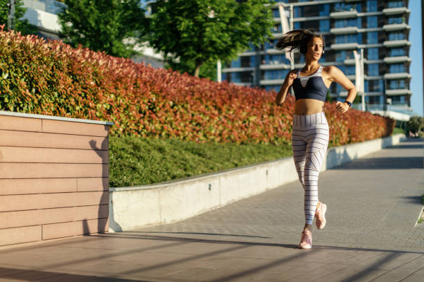 istock Young woman running in urban area 1399129764