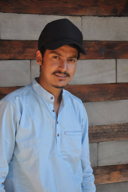 istock Waist up of a young guy with wearing cap, looking at camera while staging against wall 1399131113