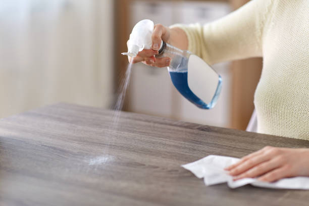 close up of woman cleaning table at home stock photo