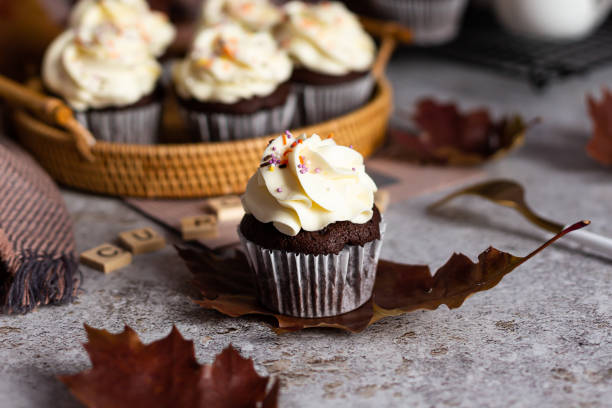 istock Delicious chocolate cupcake with a cream cap and orange sprinkles 1399132876