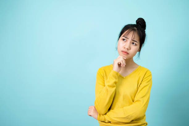 istock Young Woman poses suspiciously in the studio concept 1399133001