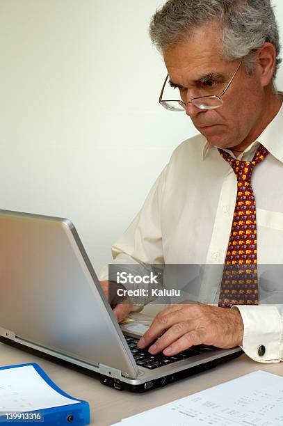 Working Stock Photo - Download Image Now - 45-49 Years, 50-54 Years, 55-59 Years