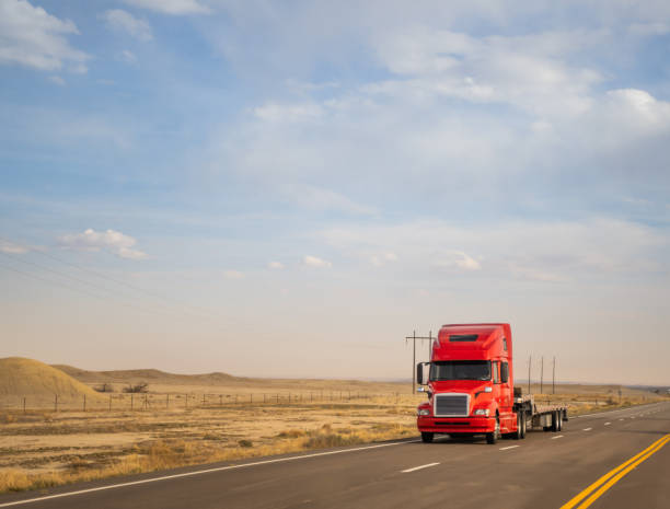 istock Red semi-truck swith an empty bed speeding in Utah 1399133854