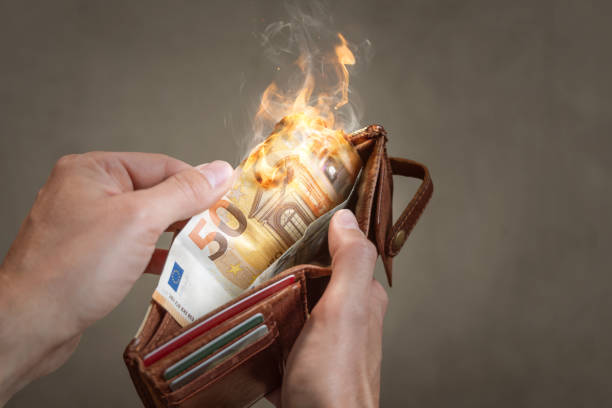 A burning 50 Euro bill in a wallet stock photo