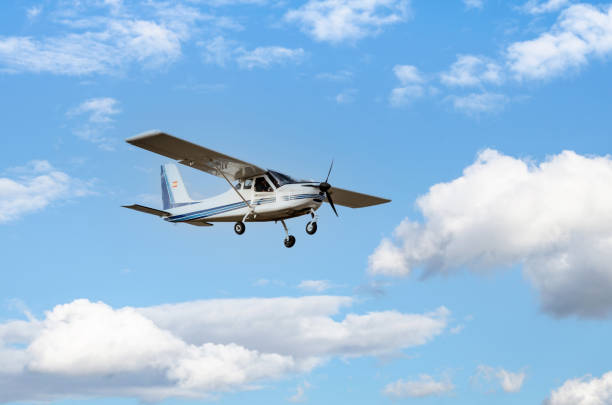 istock Light aircraft flying over blue sky 1399135114