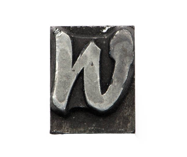 istock close up lead letter metal W white background 1399136356