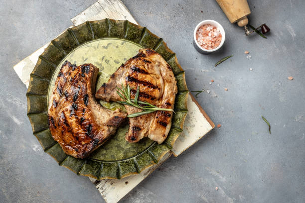 istock Grilled pork chops with rosemary on gray background. Top view, banner, copy space 1399137918