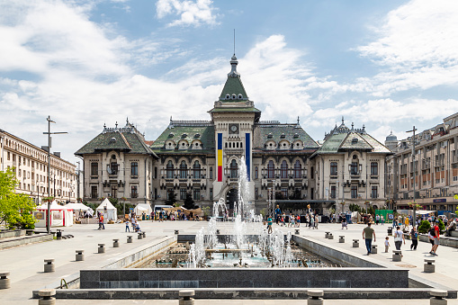 Craiova, Dolj, Romania – May 14, 2022: Dolj County Prefecture and the administrative palace in Craiova City, Oltenia, Romania. The medieval festival Michael the Brave ( Mihai Viteazul ) takes place here on May 13-15, 2022