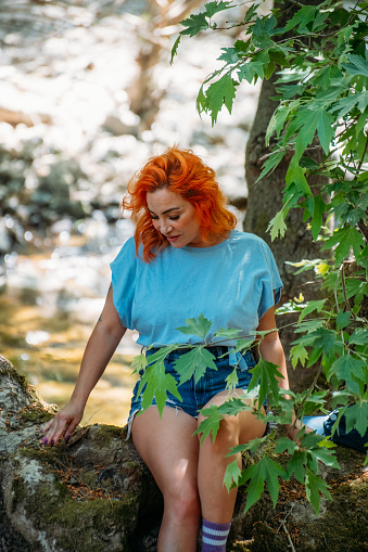 Beautiful Redhead Woman in the Untouched Forest and River