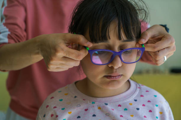 Doctor giving the child new glasses stock photo