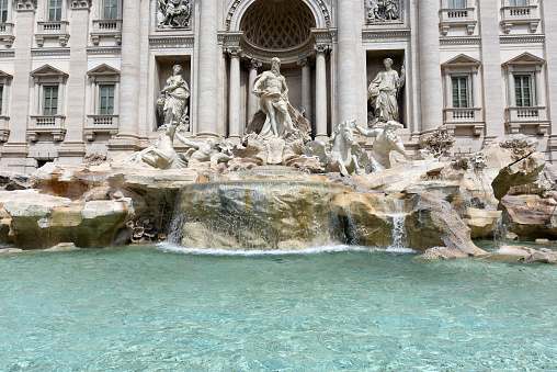 The Trevi Fountain is an 18th-century fountain in the Trevi district in Rome, Italy, designed by Italian architect Nicola Salvi. The image shows the fountain during a hot day in summer.