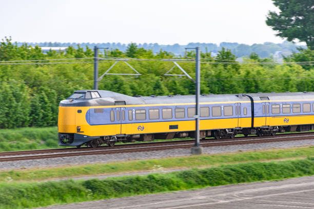 intercity train of the dutch railways driving past - ns stockfoto's en -beelden