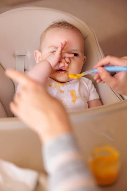 istock Baby making funny faces while refusing to eat porridge 1399142185