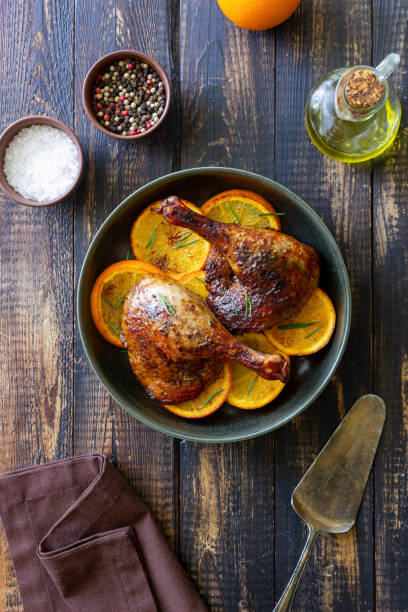 istock Baked duck legs with oranges and rosemary. Rustic style. 1399142894