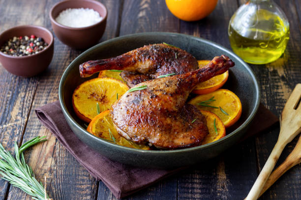 istock Baked duck legs with oranges and rosemary. Rustic style. 1399142990