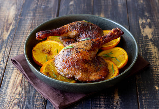 istock Baked duck legs with oranges and rosemary. Rustic style. 1399143014
