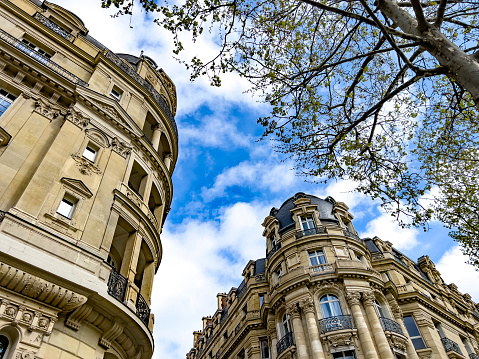 Typical French apartments from low angle with cloudy sky.
