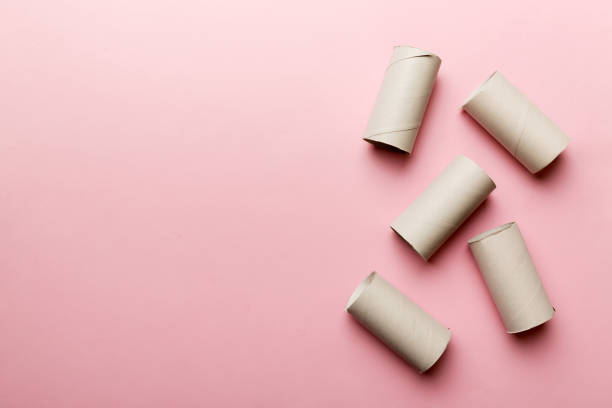 istock Flat lay composition with empty toilet paper rolls and space for text on color background. Recyclable paper tube with metal plug end made of kraft paper or cardboard 1399143131