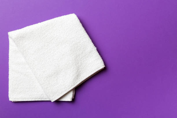 istock Top view of white towels with copy space on colored background 1399143145
