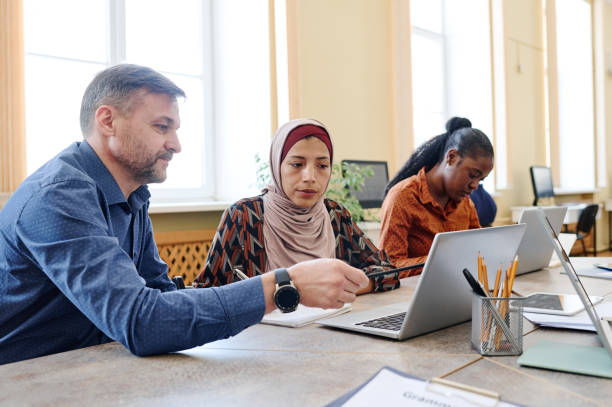 istock Teacher Showing Something To Student 1399143726