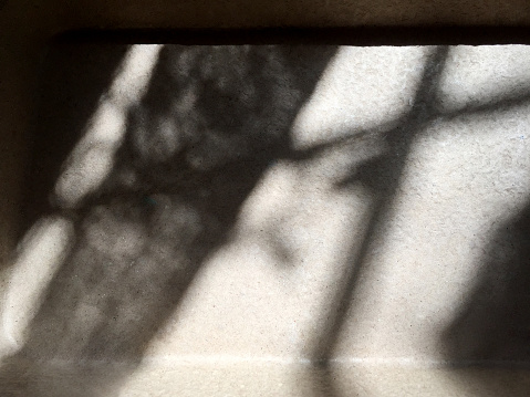 Sunlight reflection and shadow on the ceramics tiled floor
