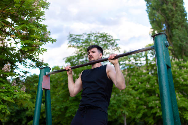 istock Male athlete pulls up on the bar, close-up 1399147040