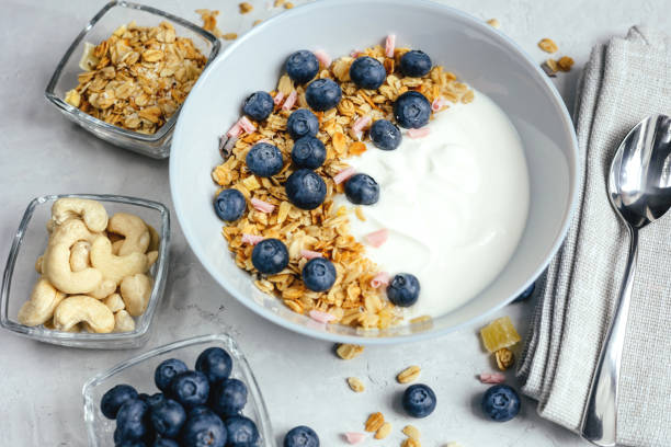 istock Yogurt with muesli and berries on a gray background. 1399148019