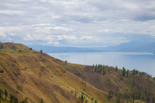istock toba lake green hills cloudy sky 1399148180