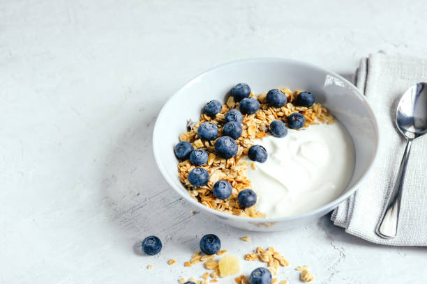 istock Yogurt with muesli and berries on a gray background. 1399148350