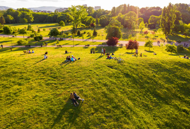 istock People enjoying evening sunlight in local park area 1399149405