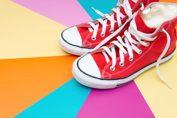 istock Red canvas shoes on a multicolored background 1399149849