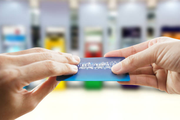 istock man holding mobile phone with blur ATM 1399150003