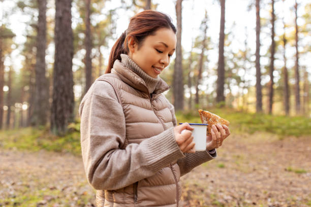 istock woman with mushrooms drinks tea and eats in forest 1399151080