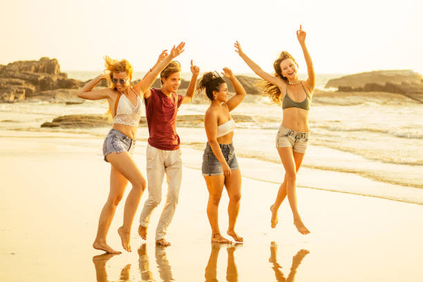 istock Multi-ethnic group of friends dance at the beach 1399151253