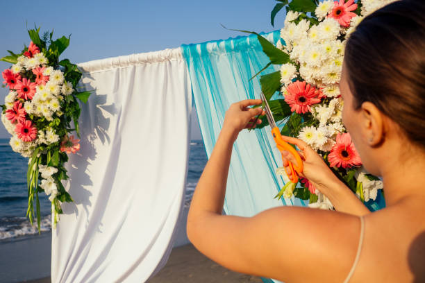 istock Decorator working with flowers composition for wedding arch on ocean beach 1399151857