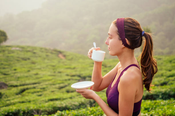 istock woman drinking tea cup factory in India Munnar 1399152076