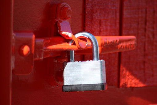 Silver padlock on red background
