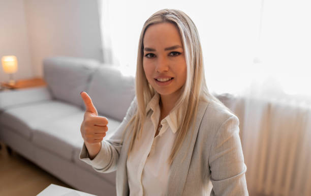 istock Young woman using computer laptop doing happy thumbs up gesture with hand. Approving expression looking at the camera with showing success. 1399155846