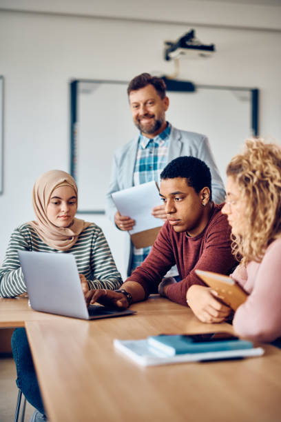 istock Multiracial group of students e-learning on laptop in the classroom at the university. 1399156263