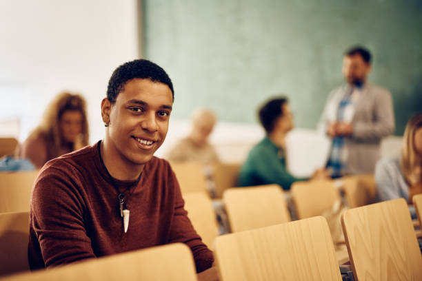 istock Happy black student during a class at college looking at camera. 1399156358