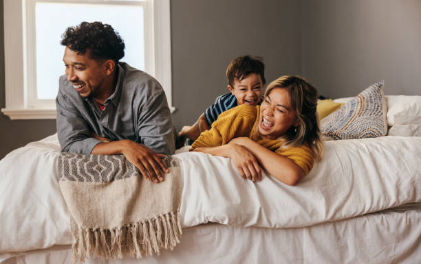 istock Ethnic parents having fun with their son at home 1399156612