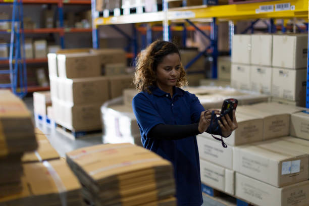 istock Woman worker using barcode machine checking products or parcel goods on shelf pallet in industry factory warehouse. Inspection quality control 1399156732