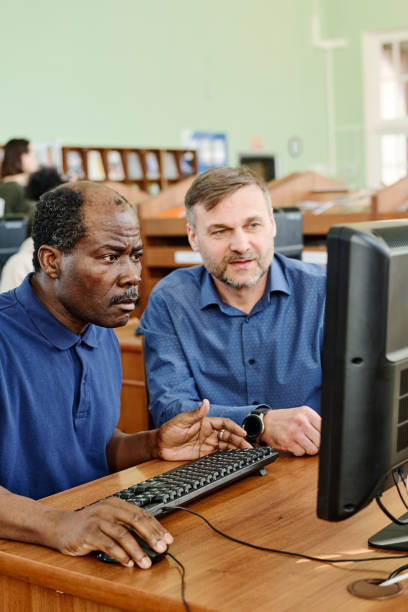 istock Teacher Working With Mature Black Man 1399157342