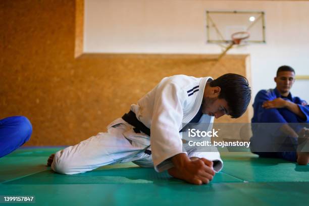 Martial Artists Stretching Before Training Stock Photo - Download Image Now - Stretching, Taekwondo, Active Lifestyle