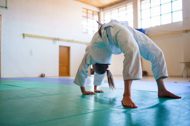 istock Young female judoka stretching before training 1399157870