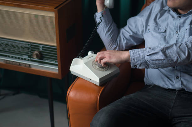 istock Special secret agent speaking by old landline phone. Spying or intelligence gathering. Espionage concept. Report information to superiors. 1399158981